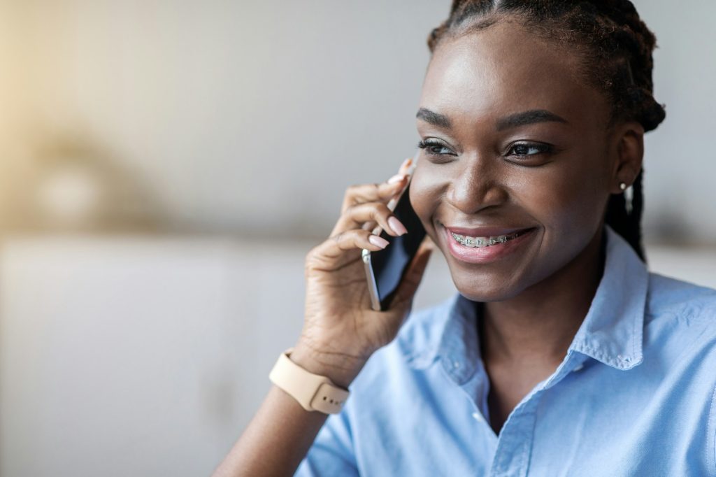 Phone Call. Smiling African American Woman With Braces Talking On Cellphone